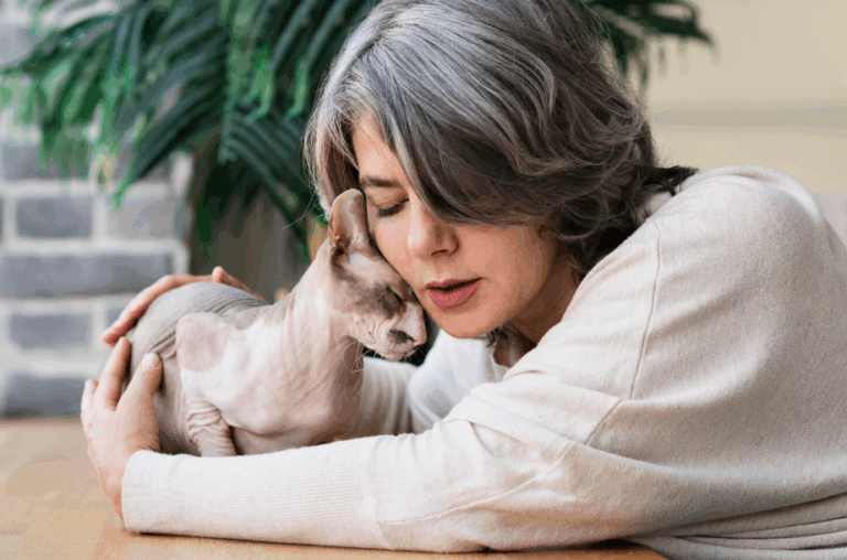 Woman lovingly cuddling a cat, highlighting the compassion and joy of special needs pet adoption